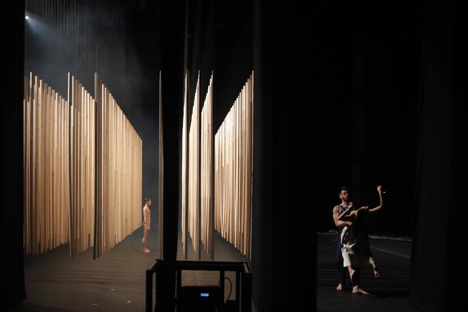 Giannis Mitrakis holding Elpida Skourou, right, and Elena Kekkou, dancers of the Greek National Opera Ballet, perform during a rehearsal of "Despo-Greek Dances" Opera and dance performance in Athens, Friday, Feb. 26, 2021. Dozens of museum exhibitions, theater productions, discussion panels and historical re-enactments were planned in Greece for this year to commemorate the bicentennial of the 1821-1832 Greek War of Independence. But due to the coronavirus pandemic, mezzo-soprano Artemis Bogri and her fellow singers stepped onstage in an empty theater to perform the Greek National Opera’s new production of “Despo,” one of the events marking 200 years since the war that resulted in Greece’s independence from the Ottoman Empire and rebirth as a nation. (AP Photo/Thanassis Stavrakis)