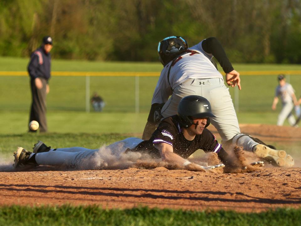 Granville Christian's Josh Benvie beats the ball to home plate as Liberty Christian's Evan Dupler takes the throw on Thursday.