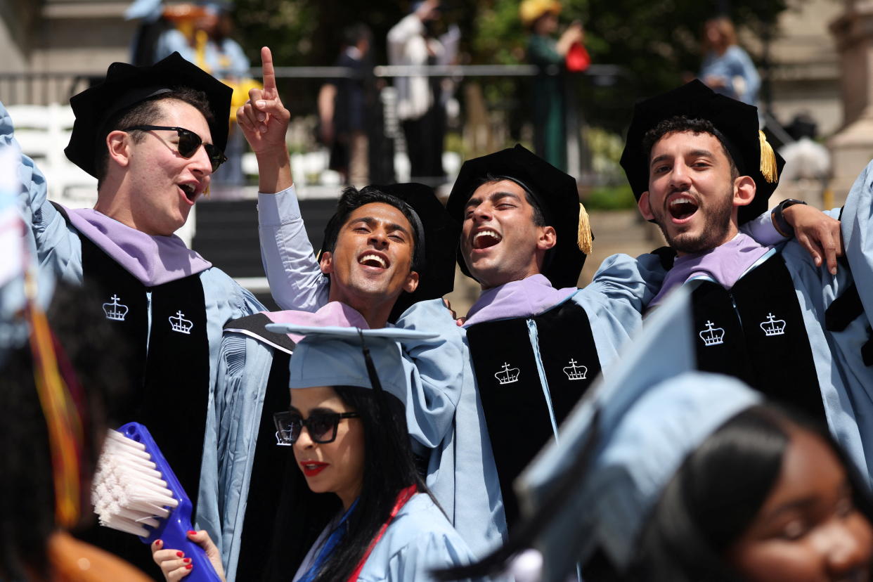 Graduates react during the Columbia University commencement ceremony in Manhattan, New York City, U.S., May 18, 2022. REUTERS/Andrew Kelly