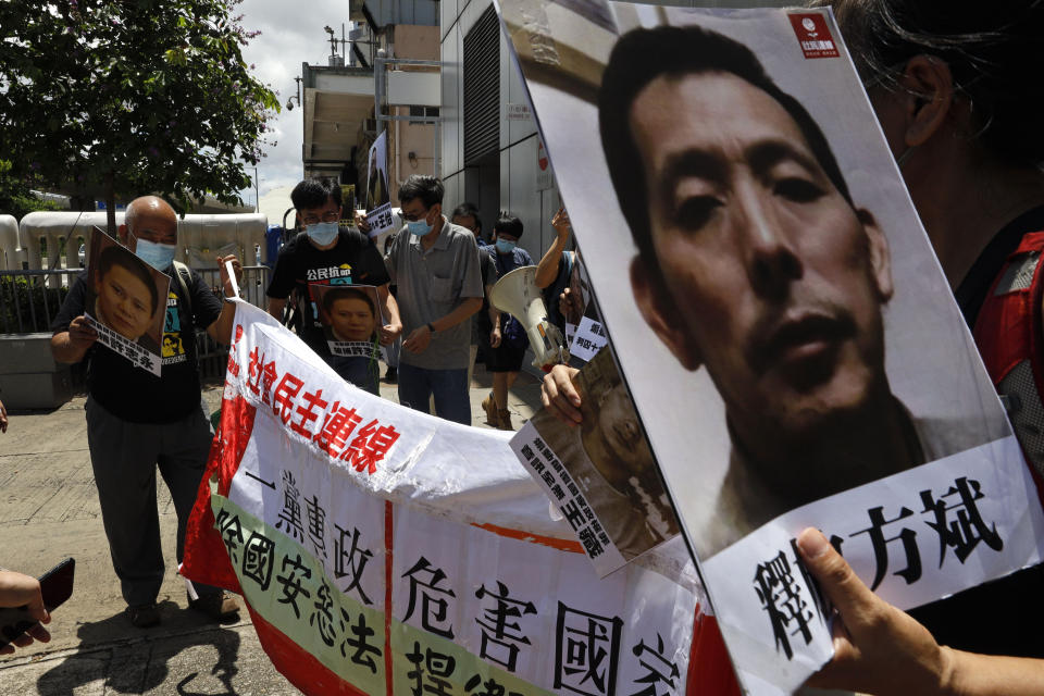 Pro-democracy demonstrators hold up portraits of jailed Chinese civil rights activists, lawyers and legal activists as they march to the Chinese liaison office in Hong Kong, Thursday, June 25, 2020. They demand to abolish the national security law and defend human rights and freedom in Hong Kong. (AP Photo/Kin Cheung)