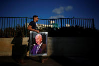 <p>A man carries a large portrait of former Israeli President Shimon Peres near the Peres Academic Center in Rehovot, Israel on Sept. 28, 2016. (REUTERS/Amir Cohen) </p>