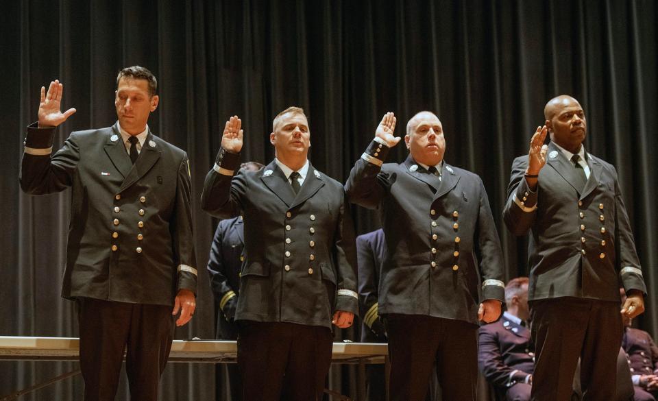 Timothy Ridick, left, Thomas Coyle, Robert Judge, and William Mosley, are sworn in as new district chiefs during a ceremony Thursday at Worcester Technical High School.