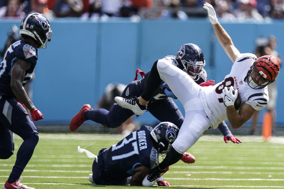 Tennessee Titans safety Amani Hooker (37) trips up Cincinnati Bengals tight end Tanner Hudson (87) during the first half of an NFL football game, Sunday, Oct. 1, 2023, in Nashville, Tenn. (AP Photo/George Walker IV)