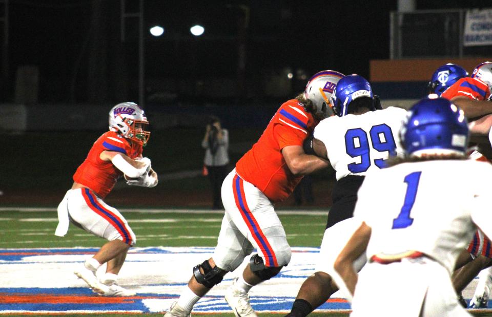 Bolles running back Kade Frew (8) looks for running room against Trinity Christian in the Bulldogs' win in 2021.