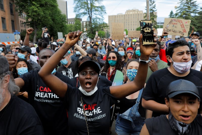 People react after a memorial service for George Floyd following his death in Minneapolis police custody, in Minneapolis