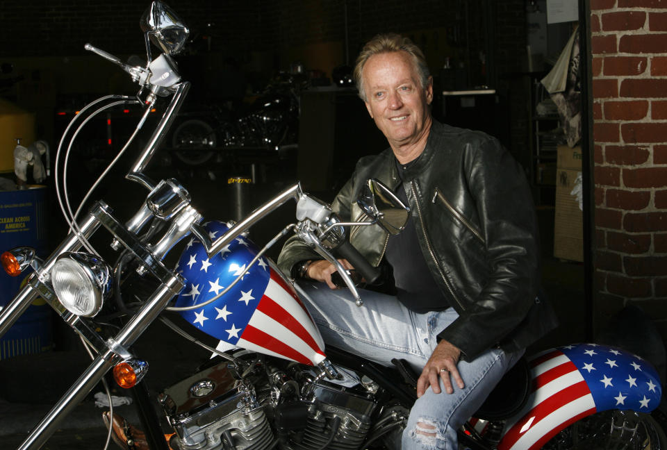 Actor Peter Fonda poses for a portrait on a replica of the "Captain America" bike in Glendale, California October 23, 2009. Fonda was promoting the recent release on blu-ray disk of the 1969 movie "Easy Rider" on its 40th anniversary.   REUTERS/Mario Anzuoni   (UNITED STATES ENTERTAINMENT)