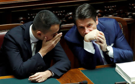 FILE PHOTO: Italian Prime Minister Giuseppe Conte and Italian Minister of Labor and Industry Luigi Di Maio speak during a final vote on Italy's 2019 budget law at the Lower House of the Parliament in Rome, Italy, December 29, 2018. REUTERS/Remo Casilli/File Photo