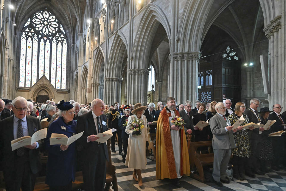 Britain's Queen Camilla, left, and Interim Dean of Worcester Cathedral The Reverend Canon Dr Stephen Edwards, right, arrive for the Royal Maundy Service where The Queen will distribute the Maundy money to 75 men and 75 women, mirroring the age of the monarch, in Worcester Cathedral, Worcester, England, Thursday, March 28, 2024. Maundy Thursday is the Christian holy day falling on the Thursday before Easter. The monarch commemorates Maundy by offering 'alms' to senior citizens. Each recipient receives two purses, one red and one white. (Justin Tallis, Pool Photo via AP)