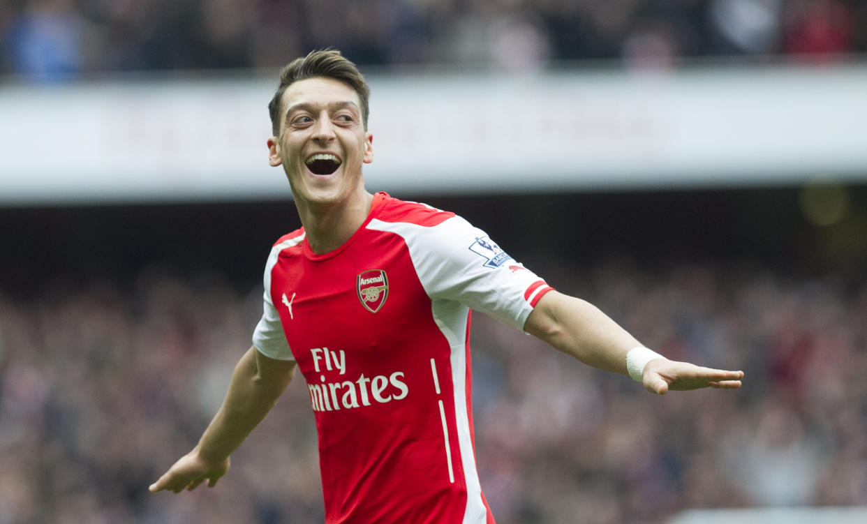Arsenal's Mesut Özil celebrates after scoring against Liverpool during their English Premier League soccer match at Emirates Stadium, in London, Saturday, April 4, 2015. (AP Photo/Bogdan Maran)