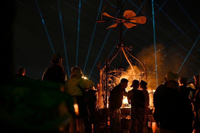 Revellers chat at Worthy Farm in Somerset during the Glastonbury Festival