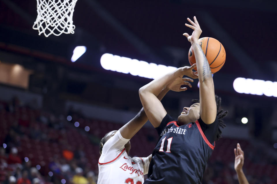 UNLV guard Amarachi Kimpson blocks a shot by San Diego State guard Jazlen Green (11) during the first half of an NCAA college basketball game for the championship of the Mountain West women's tournament Wednesday, March 13, 2024, in Las Vegas. (AP Photo/Ian Maule)