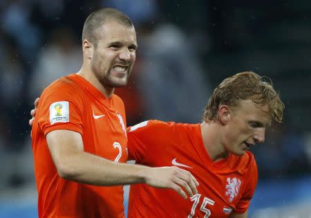 Ron Vlaar of the Netherlands (L) reacts next to teammate Dirk Kuyt after failing to score a goal during a penalty shootout in their 2014 World Cup semi-finals against Argentina at the Corinthians arena in Sao Paulo July 9, 2014. REUTERS/Sergio Moraes