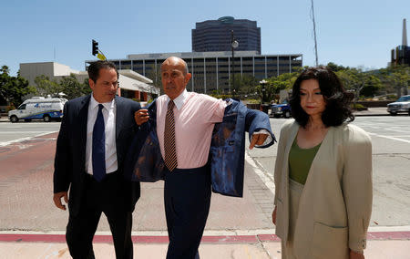 Former Los Angeles County Sheriff Lee Baca (C), accompanied by his wife Carol Chiang and his attorney David Hochman, arrives to be arraigned on charges of conspiring to obstruct justice, obstructing justice and lying to the federal government in Los Angeles, California U.S., August 12, 2016. REUTERS/Mario Anzuoni