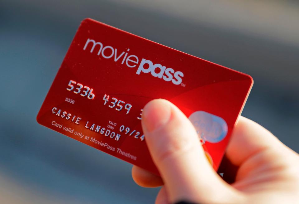 In this Jan. 30, 2018 file photo, Cassie Langdon holds her MoviePass card outside AMC Indianapolis 17 theatre in Indianapolis.