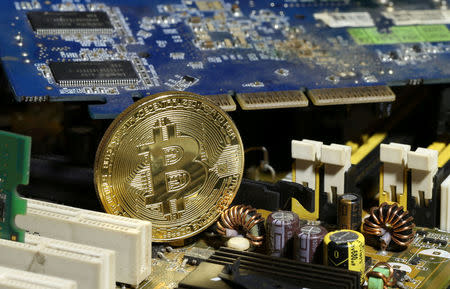 FILE PHOTO: A copy of bitcoin standing on PC motherboard is seen in this illustration picture, October 26, 2017. REUTERS/Dado Ruvic/File Photo