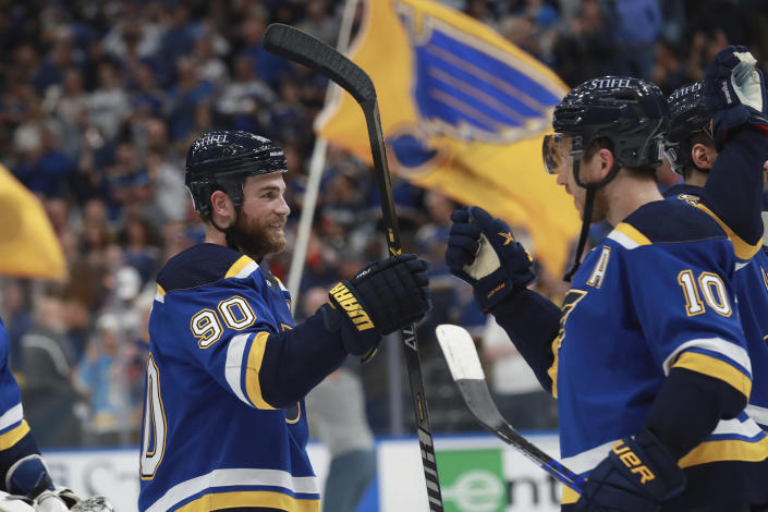 St. Louis Blues' Ryan O'Reilly (90) and Brayden Schenn (10) celebrate after the Blues defeated the Minnesota Wild in Game 6 of an NHL hockey Stanley Cup first-round playoff series Thursday, May 12, 2022, in St. Louis. The Blues advance to the second round. (AP Photo/Michael Thomas)