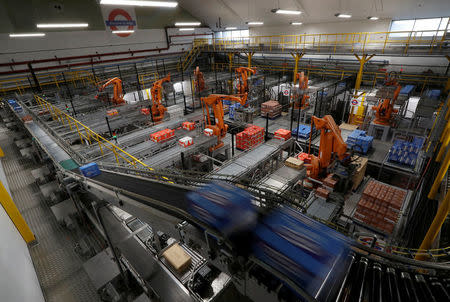 Robotic arms load biscuits onto pallets on the production line of Pladis' McVities factory in London Britain, September 19, 2017. Picture taken September 19, 2017. REUTERS/Peter Nicholls.