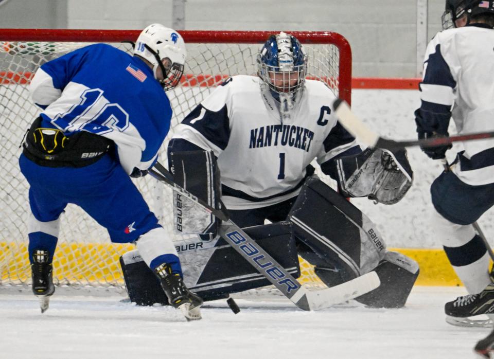 Nantucket goalie Griffin Starr deflects a shot by Greg Indelicato of Stoneham.