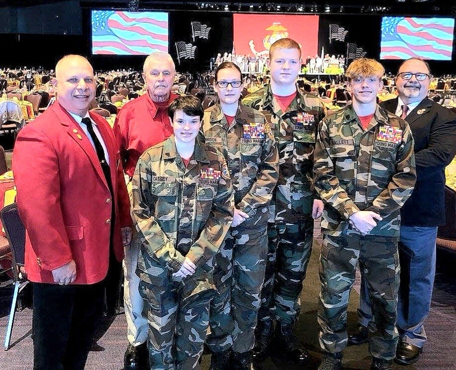 Volunteer of the year Bruce Katz, left, and Wilson Lee, right, national deputy director of the Young Marines organization, flank a group of Young Marines from the Cpl. Nicholas Xiarhos detachment on Cape Cod. George Challies, commander of the Young Marines, stands next to Katz.