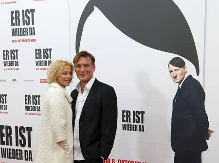 Actors Katja Riemann (L) and Oliver Masucci walk on the red carpet at the world premier of the film 'Look Who's Back' in Berlin, Germany, October 6, 2015. The film 'Look Who's Back' is an adaptation of a satirical novel by Timur Vermes about Adolf Hitler. REUTERS/Fabrizio Bensch