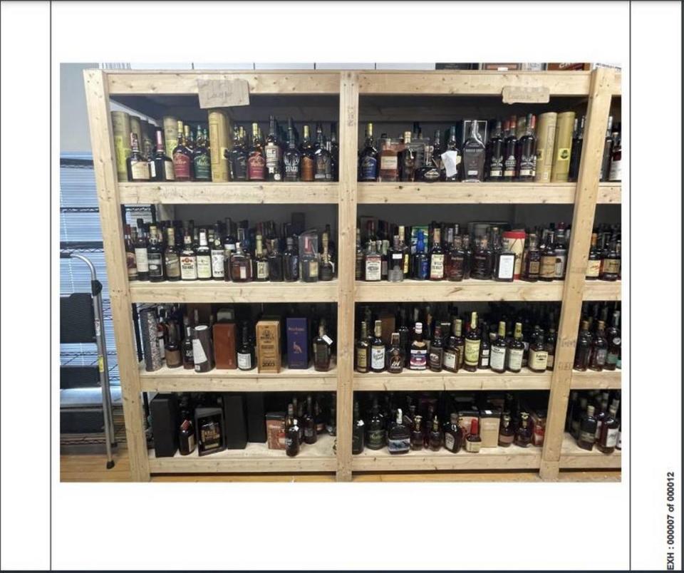 Once the seized bottles were returned, Justins’ House of Bourbon employees removed them from the state’s boxes and put them on shelves labeled by the store location where they were originally seized in January 2023.