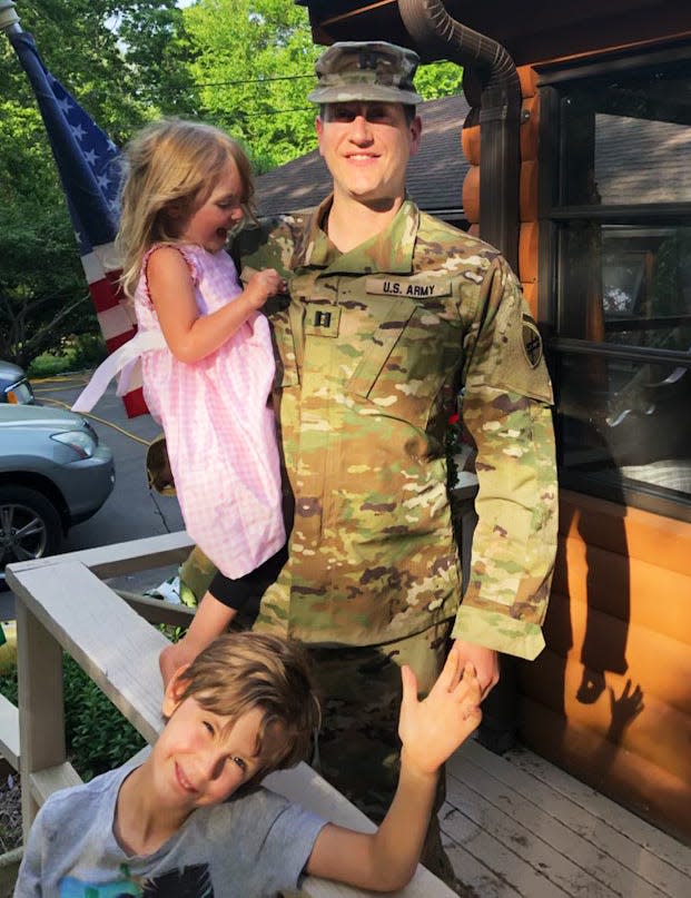 US Army Reserve Captain Blake Ruehrwein of Rehoboth with two of his three kids, Mackenzie, 2, and Asa, 6.