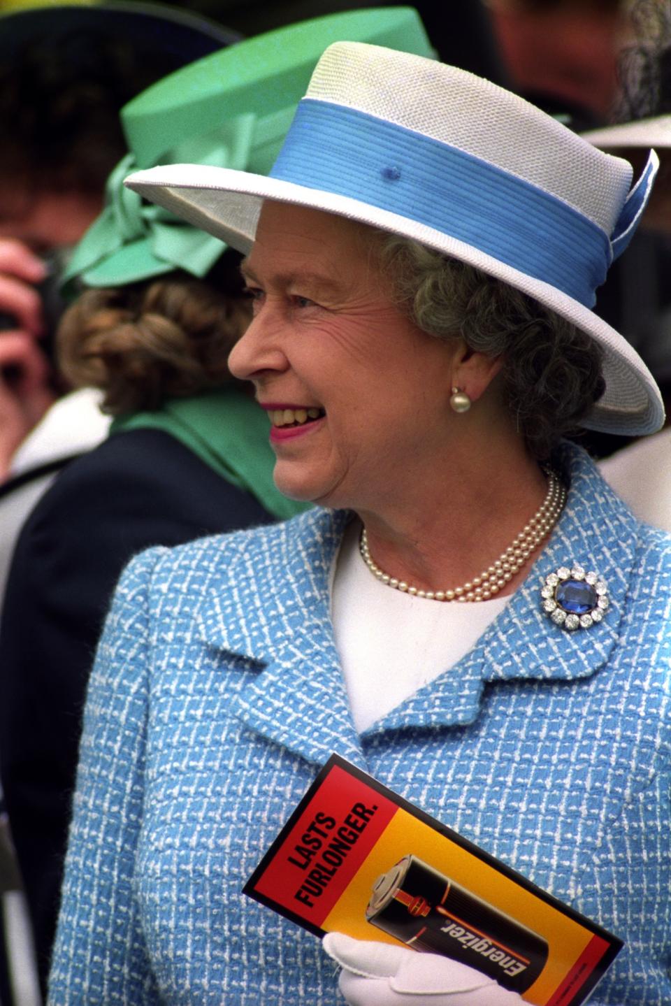 <p>The Queen opted for light blue tweet and a boater hat at the races.<br><i>[Photo: PA]</i> </p>