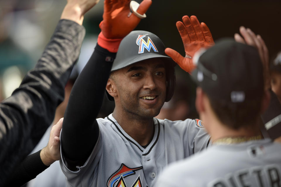 Miami Marlins' Isaac Galloway celebrates his home run in the dugout during the eighth inning of a baseball game against the Washington Nationals, Sunday, Aug. 19, 2018, in Washington. (AP Photo/Nick Wass)