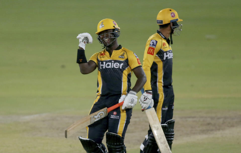 Peshawar Zalmi' Sherfane Rutherford, left, celebrates after playing winning shot during a Pakistan Super League T20 cricket match between Quetta Gladiators and Peshawar Zalmi at the National Stadium, in Karachi, Pakistan, Friday, Feb. 26, 2021. (AP Photo/Fareed Khan)