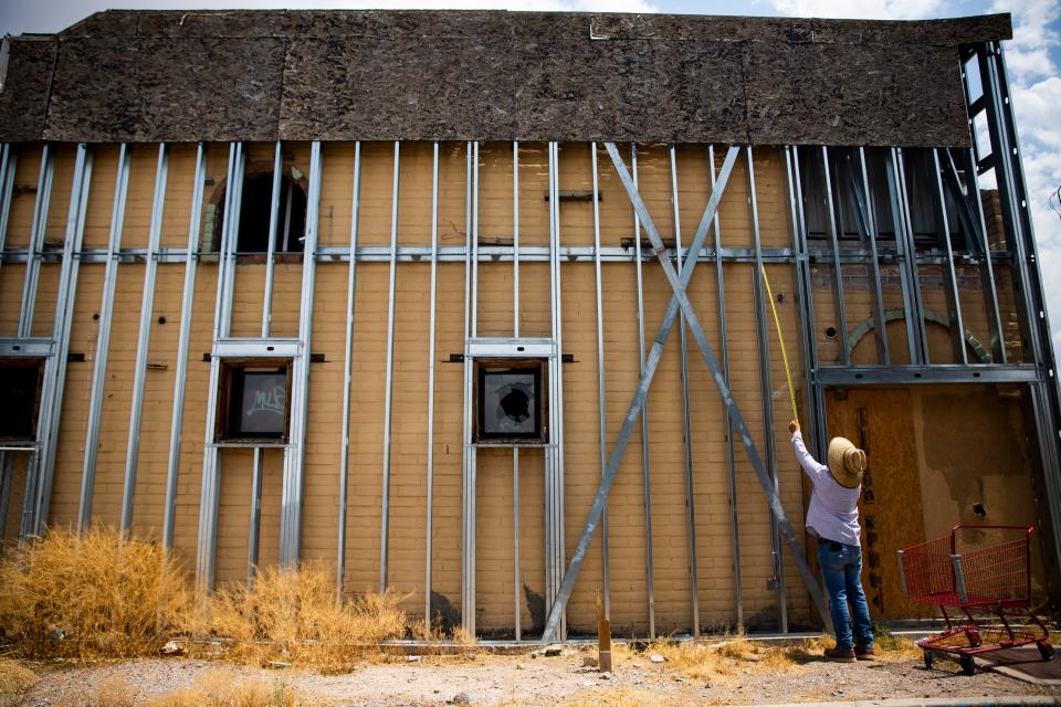 A demolishtion team takes measurements of an abandoned building on Tuesday, August 22, 2023, on the corner Main Street and Amador Avenue.