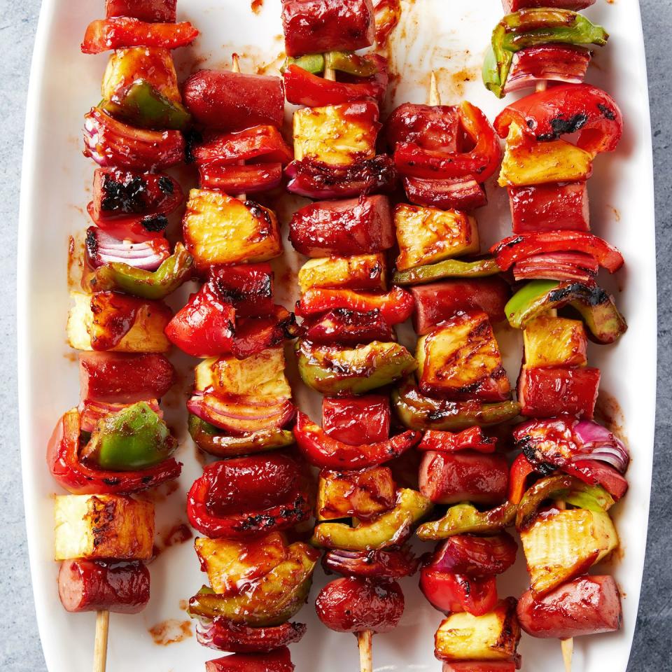 grilled skewers with sliced hot dogs, pineapple, red bell peppers basted with a bbq sauce