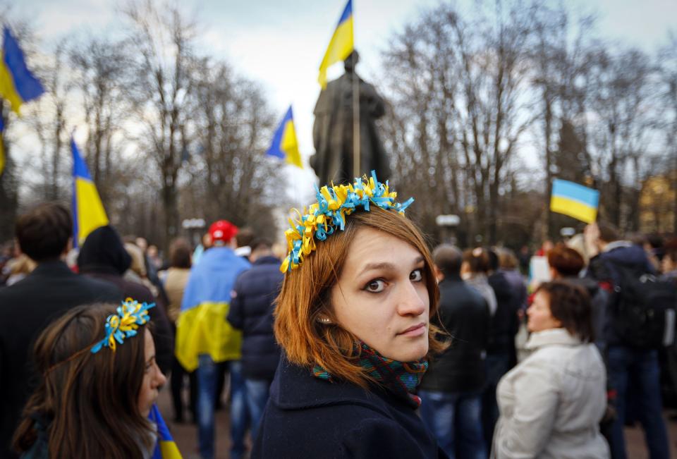 A woman wearing a national flower crown looks back as she attends a pro-Ukrainian rally in Luhansk, eastern Ukraine