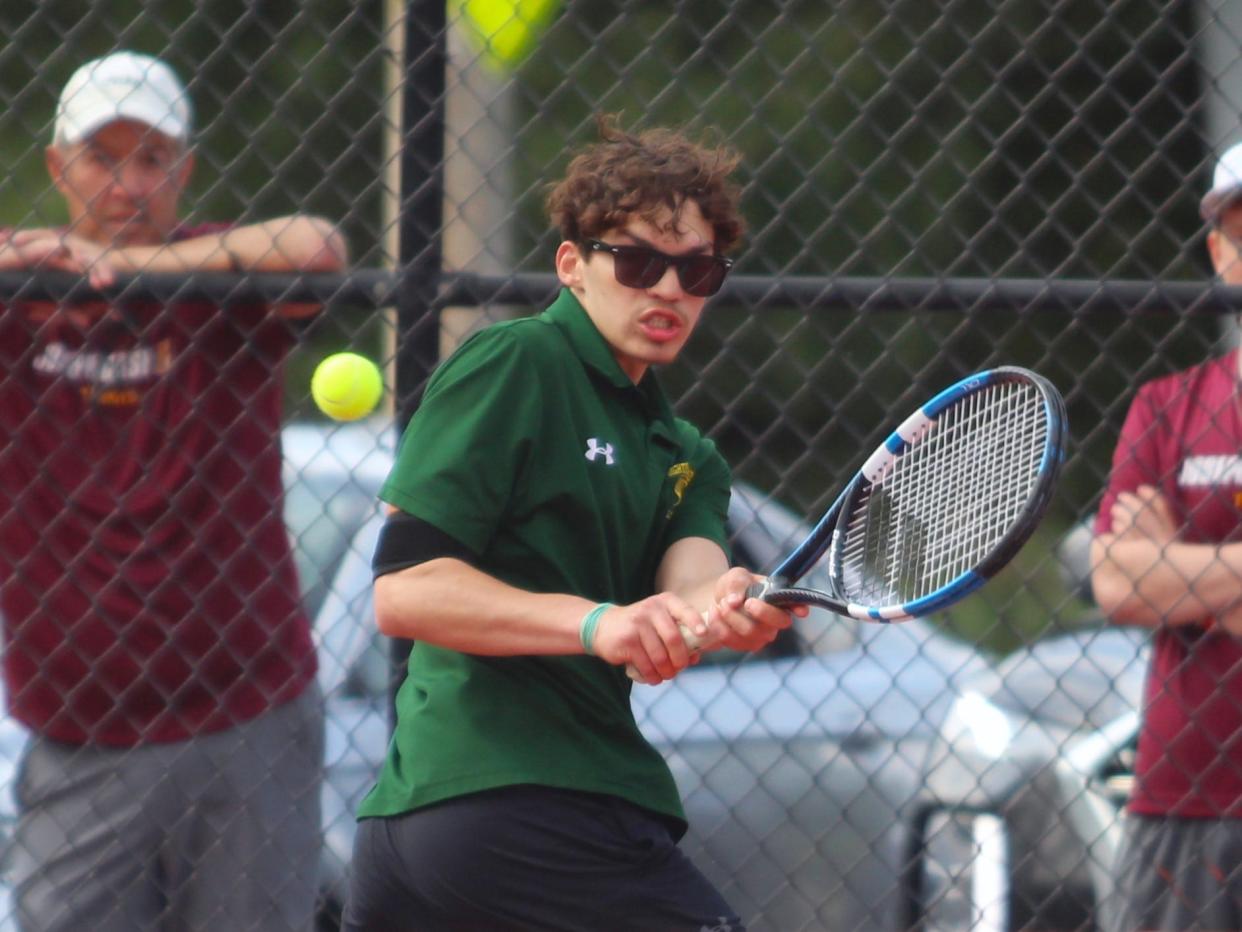 Dighton-Rehoboth's Spencer Jones turns around to return a volley during a South Coast Conference second singles match against Case.