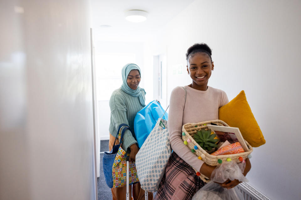 A person and their parent moving stuff into a dorm