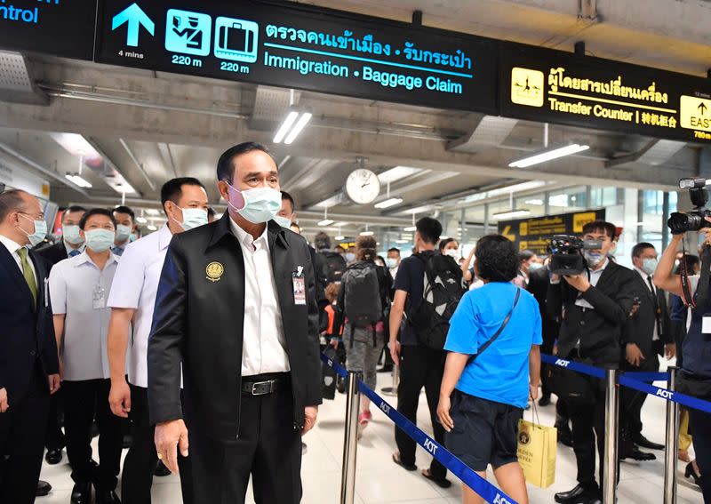 Thailand's Prime Minister Prayuth Chan-ocha wearing a protective mask is seen during a visit at the arrival hall at the Bangkok's Suvarnabhumi International airport
