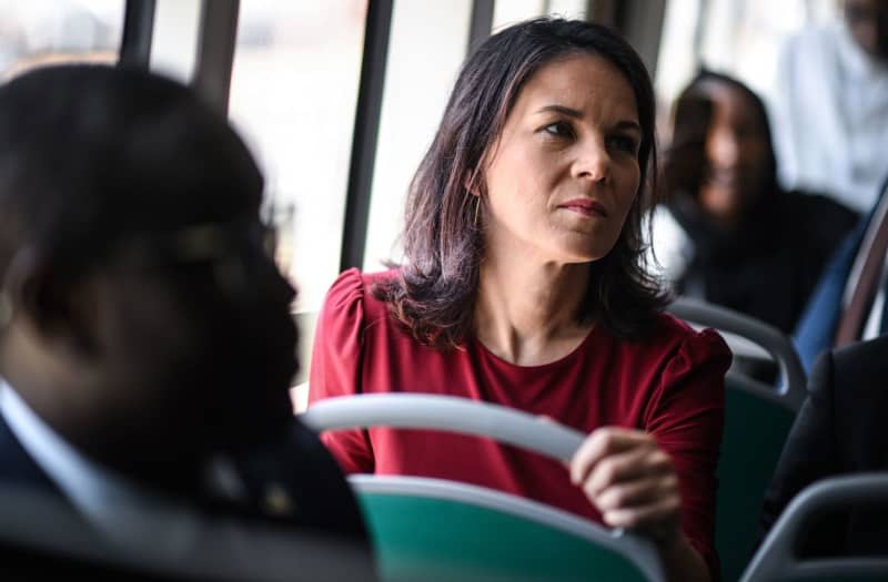 Annalena Baerbock, Germany's Foreign Minister, rides on a bus during a visit to the Bus Rapid Transit (BRT) local transport system. The trip focuses on efforts to stabilize the Sahel region. Britta Pedersen/dpa