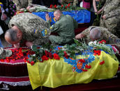 <p>Servicemen take part in a funeral ceremony for Mykola Kuliba and Serhiy Baula, servicemen from the “Aydar” battalion, who were killed in the fighting in eastern Ukraine, at Independence Square in central Kiev, Ukraine May 26, 2016. (Gleb Garanich/REUTERS) </p>