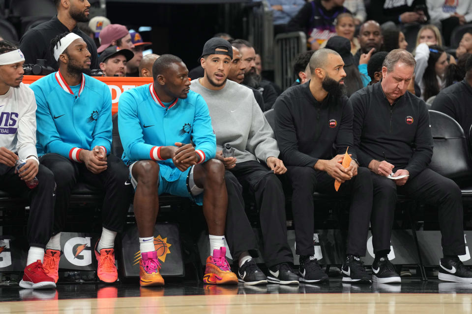 Jan 8, 2023; Phoenix, Arizona, USA; Phoenix Suns guard Devin Booker (gray sweatshirt) looks on against the Cleveland Cavaliers during the second half at Footprint Center.