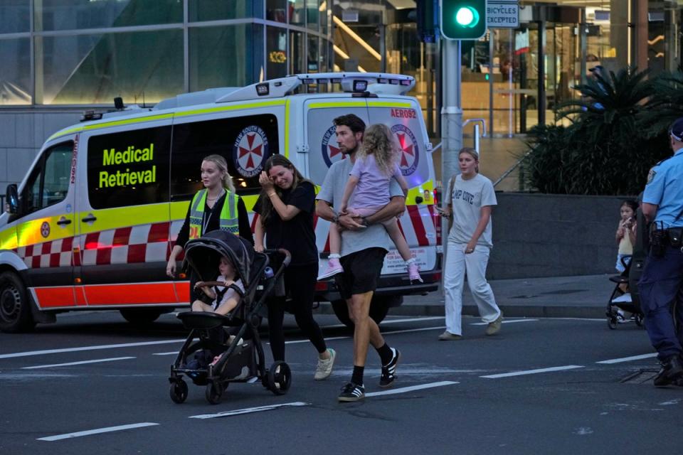 Emotional shoppers being evacuated from the shopping mall (AP)