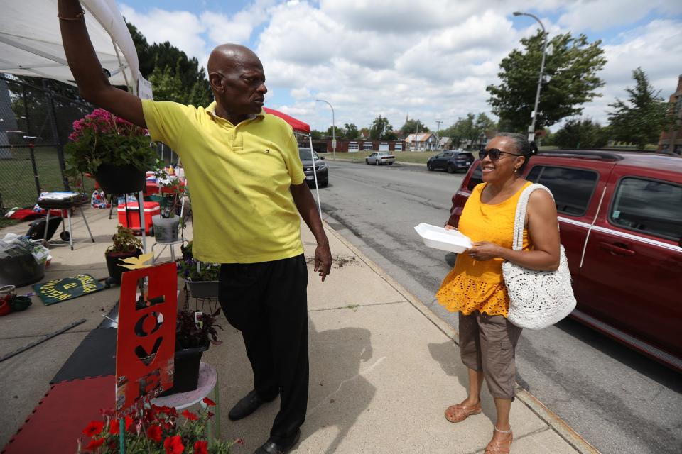 Reggie Garner of Buffalo tries to sell some of his plants at the outdoor market, Kuleta Pamoja (Swahili for come together), to Terry Patterson on July 30, 2022, who laughs at his selling technique, which is humorous. The Kuleta Pamoja is held throughout the summer on Saturdays on Jefferson Avenue in Buffalo.