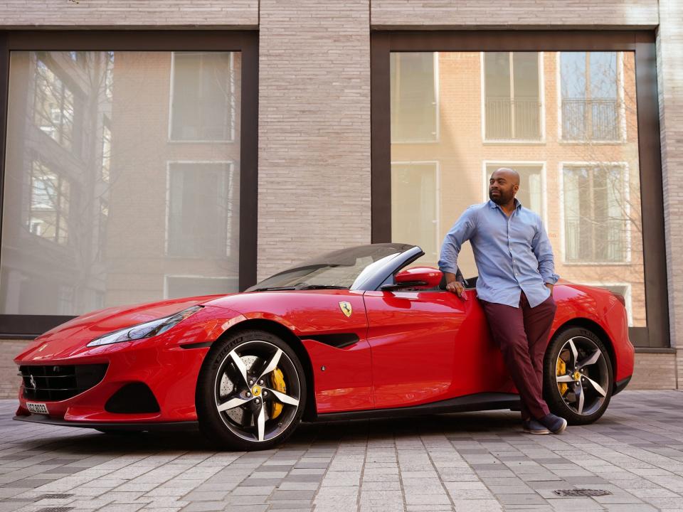 Starr Luxury Cars's CEO poses next to the Ferrari Portofino.
