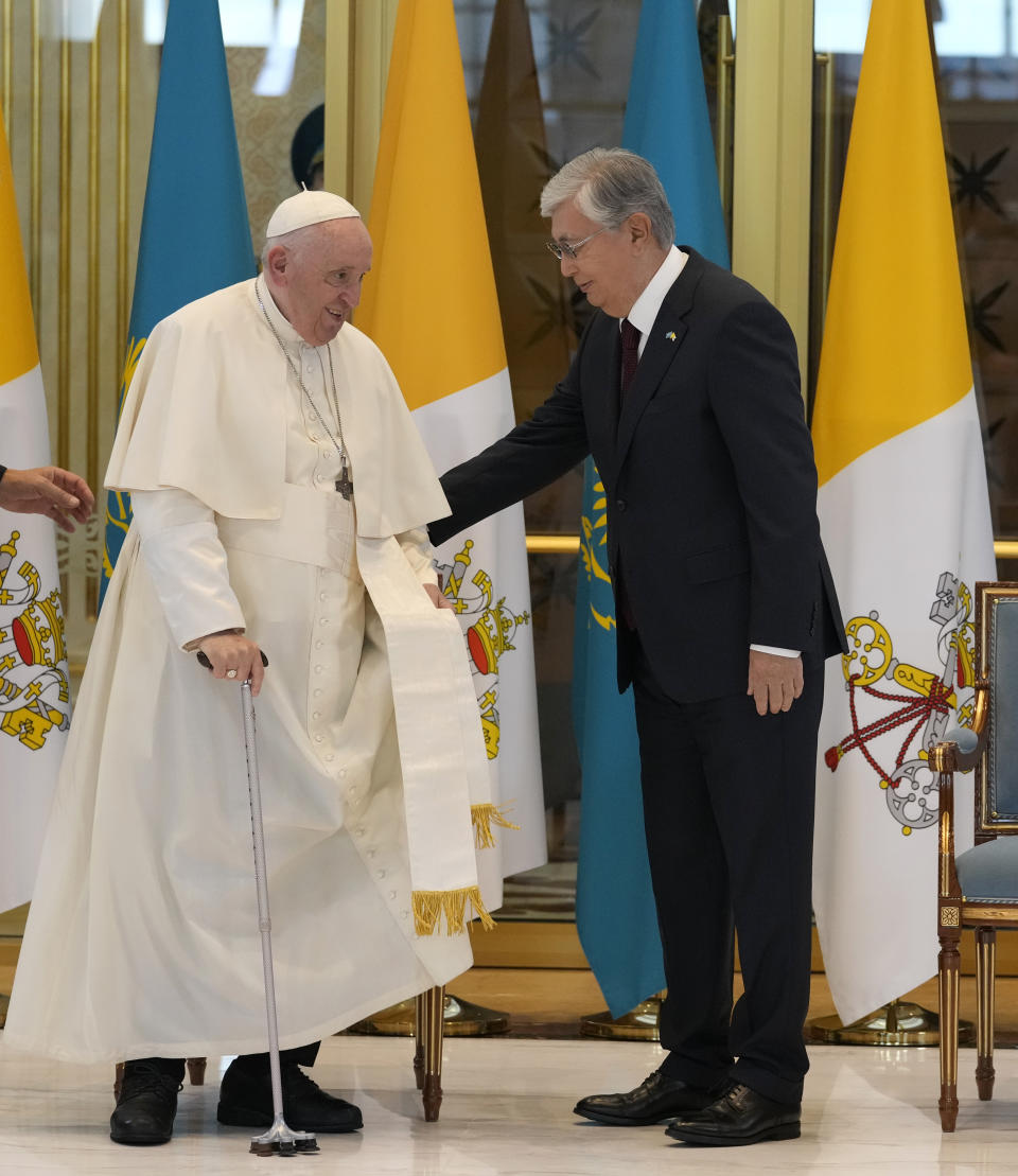 Pope Francis, left, meets the Kazakhstan's President Kassym-Jomart Tokayev as he arrives at Our-Sultan's International airport in Nur-Sultan, Kazakhstan, Tuesday, Sept. 13, 2022. Pope Francis begins a 3-days visit to the majority-Muslim former Soviet republic to minister to its tiny Catholic community and participate in a Kazakh-sponsored conference of world religious leaders. (AP Photo/Andrew Medichini)