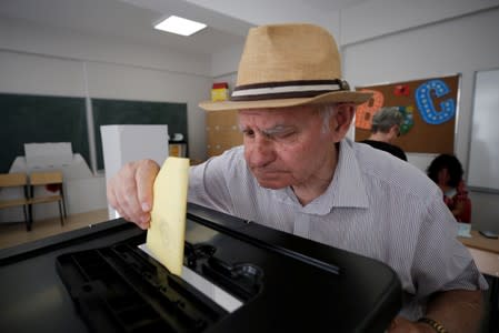 A man casts a vote at a voting centre in Tirana