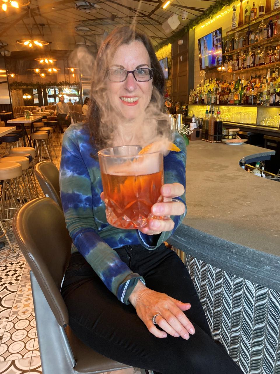 Lohud Food & Dining Reporter Jeanne Muchnick with the  Good 'Ol Smokey from Archie Grand in White Plains. Photographed May 13, 2022.