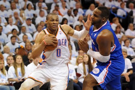 May 13, 2014; Oklahoma City, OK, USA; Oklahoma City Thunder guard Russell Westbrook (0) handles the ball against Los Angeles Clippers forward Glen Davis (0) during the fourth quarter in game five of the second round of the 2014 NBA Playoffs at Chesapeake Energy Arena. Mandatory Credit: Mark D. Smith-USA TODAY Sports