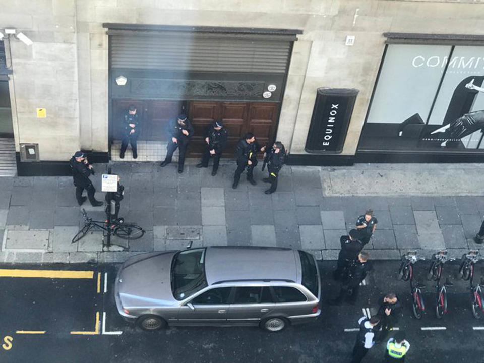 Armed police can be seen outside a building in Kensington, central London (Trish Ellis/PA Wire)