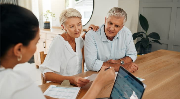 A retired couple meets with their financial advisor to talk about their income plan. 