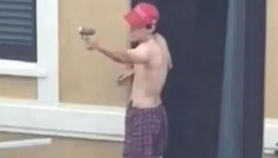 Nikolas Cruz is seen practicing shooting wearing a MAGA hat (CNN)