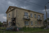 A man walks into his home damaged by Russian strikes, in Yahidne village, northern Chernihiv region, Ukraine, Wednesday, June 29, 2022. A few months after Russian troops retreated from Yahidne, the village has gradually returned to life. People are repairing their homes, and a strong wind occasionally picks up the bitter smell of ashes. (AP Photo/Nariman El-Mofty)