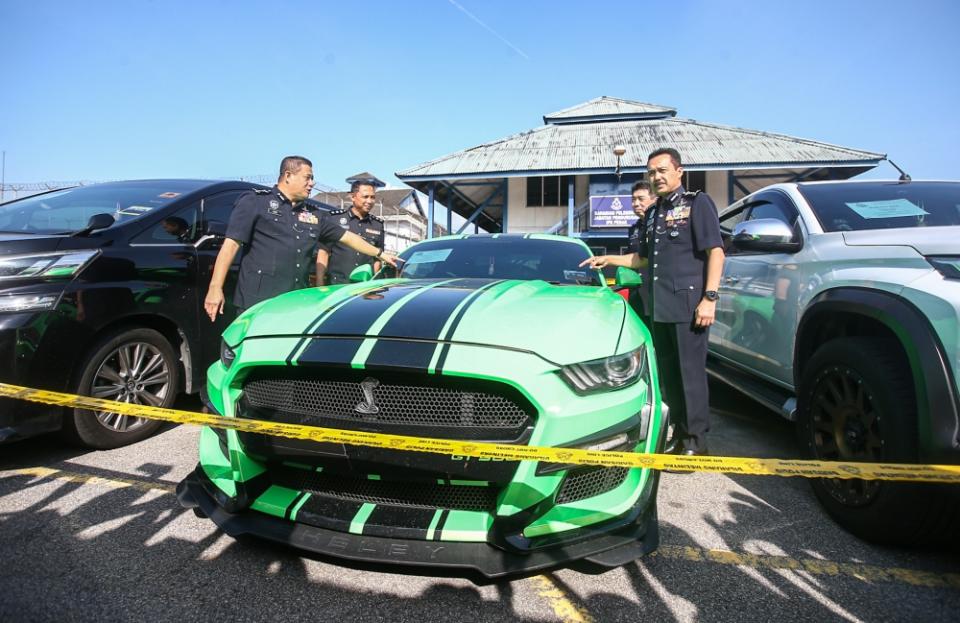 Perak Police Chief Commissioner Datuk Seri Mohd Yusri Hassan Basri shows the seized cars from two drug busts at Perak Police Contingent in Ipoh April 4, 2023. — Picture by Farhan Najib